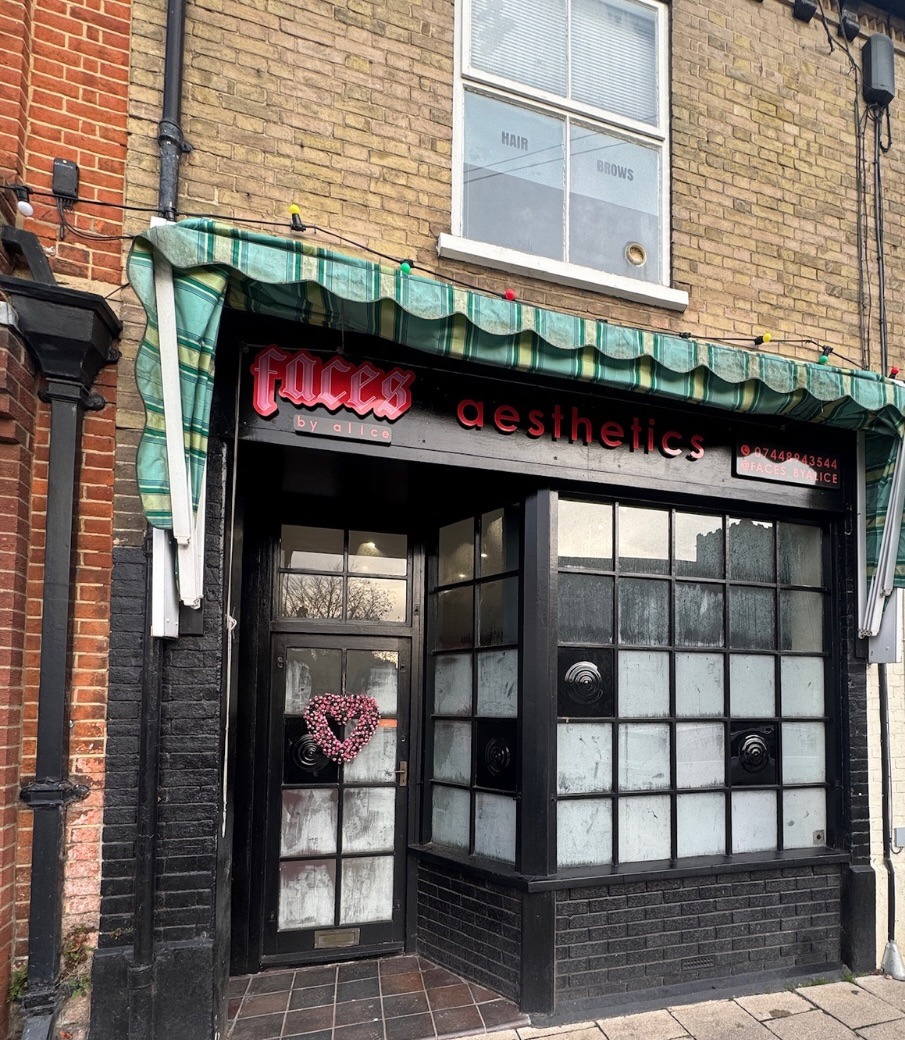 The FACES by Alice clinic on Church Street, Attleborough: black shopfront with the faces by alice aesthetics sign and a heart wreath on the door